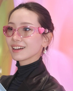 Close-up of pink Y2K heart sunglasses featuring a 3D heart detail on the temple