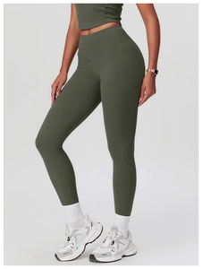 Detail view of high waist yoga leggings and crop top in olive green stretch fabric
