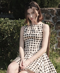 Detail of a sleeveless plaid dress with button-down front and black and white check pattern