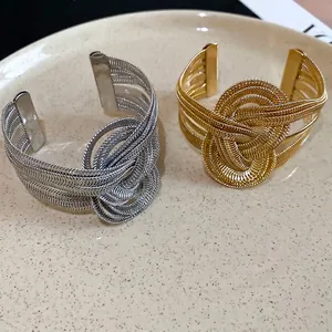 Minimalist woven metal open bangles in gold and silver finish with knot design