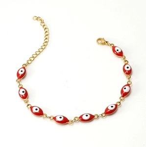 Detailed close-up of 18K gold-plated chain bracelet with red evil eye beads and lobster clasp