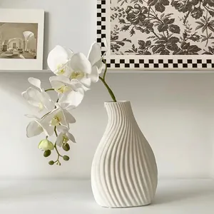 Minimalist white ceramic vase with spiral texture and orchid for modern home decor