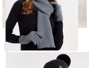 Three-piece winter knit set with a gray scarf, gloves, and a black pom-pom beanie