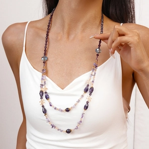 Detailed view of layered purple beaded necklace with amethyst glass and golden spacers