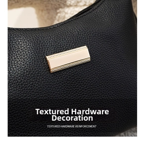 Detailed close-up of textured black lychee leather with a rectangular golden hardware buckle