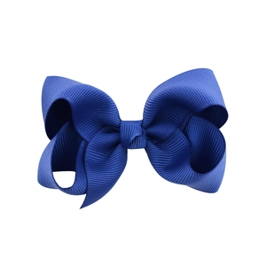 Detailed view of a dark blue grosgrain ribbon bow hair clip with fine ribbed texture