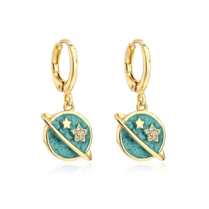 Macro detail of gold-plated hoop earrings with teal planet charms and star accents