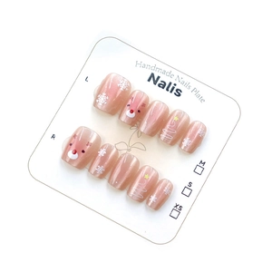 Christmas cat-eye press-on nails with handmade reindeer and snowflake festive designs