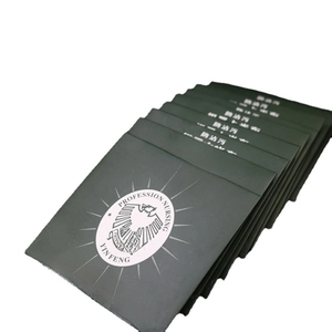 Thick dark green double-sided silver polishing cloths stacked on a white background