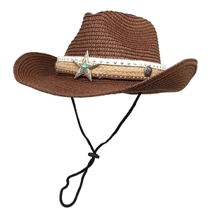 Detail of western straw hat featuring a star metal badge and turquoise stone accent