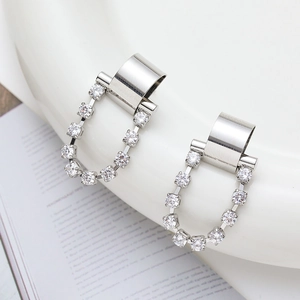 Elegant silver U-shaped hoop earrings with micro-set zircons on a white surface