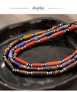 Macro detail of natural tiger eye and lapis lazuli stone beads with silver spacers