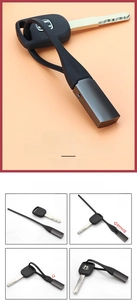 Detail of minimalist black silicone key ring with menu branding and metal clasp