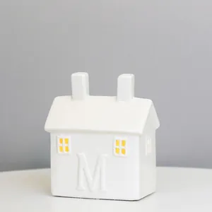 White ceramic LED house with M letter relief and dual chimneys, size 10x6.3x12cm