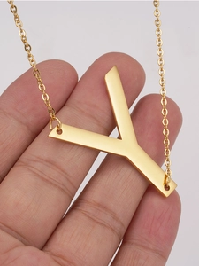 Detailed view of 18K gold plated stainless steel letter Y pendant necklace held by hand