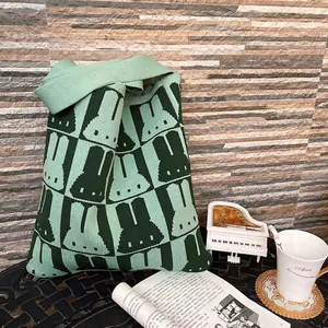 Green knitted tote bag with cartoon rabbit pattern and wide comfortable handles