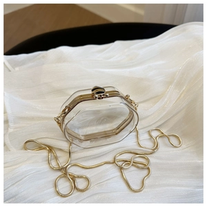 Close-up of hexagonal acrylic jelly bag with gold bee buckle and chain strap