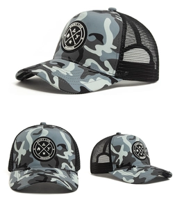 Detail of camouflage trucker hat featuring breathable black mesh and circular embroidered patch