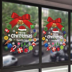 Christmas window decals featuring red bows and gold bells on festive wreaths
