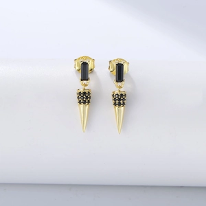 Detailed macro view of S925 silver cone earrings with gold finish and black zircon stones