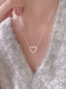 Close-up of 925 sterling silver heart pendant necklace with zircon on a model