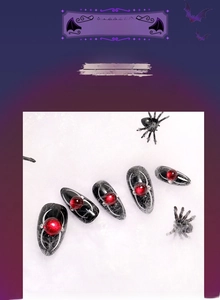 Design nail art ragnatela con perline rosse su unghie finte Halloween a mandorla a pressione