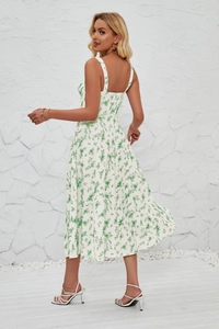Detail of French sleeveless floral dress showing side slit and summer print pattern