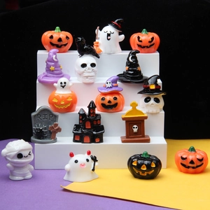 Macro detail of miniature resin Halloween charms including pumpkins, ghosts and skulls