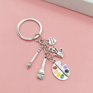Art theme keychain with palette, brush and Thank You heart charm on pink background