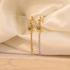 Detail of long fringe rhinestone earrings with clover motif and turquoise stone