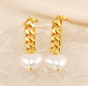 Detailed view of 18K gold chain earrings with white heart-shaped pearl pendants