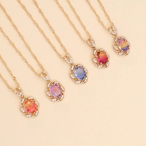 Detail of sunflower pendant necklaces in five colors with sparkling crystals and gold plating