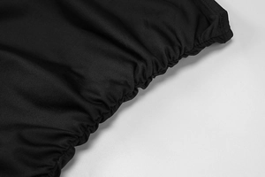 Detailed macro shot of the black elastic ruched fabric and pleats on a summer dress