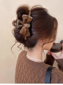 Detail showing the brown velvet bow hair claw clip with a high-quality soft texture