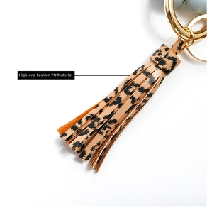 Detail of leopard print PU leather tassel with a polished gold metal keyring