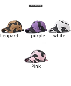 Detailed close-up of cotton baseball caps in various cow print colors with vibrant textures