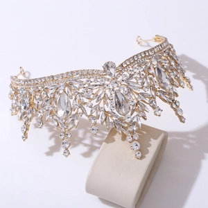 Close-up of golden crystal bridal crown with marquise and teardrop stones on velvet
