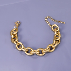 Detail of chunky gold stainless steel chain bracelet with lobster clasp and extension
