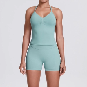 Front view of seamless light blue yoga set with halter v-neck top and high waist shorts
