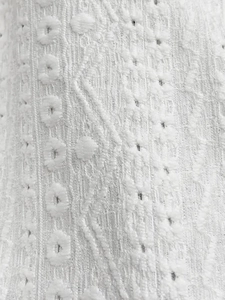Elegant white cardigan with openwork eyelet embroidery and fine jacquard texture fabric