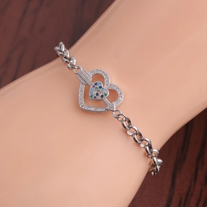 Silver steel bracelet featuring heart pendant with multicolor gems and cupid arrow detail