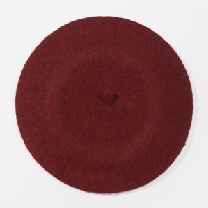 Top-down view showing smooth wool texture and circular shape of the wine red beret hat