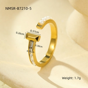Close-up of gold open C-ring with five pearls and a rectangle bar set with zircon
