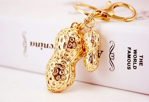 Macro shot of gold peanut pendants with detailed texture on a metal lobster clasp keychain