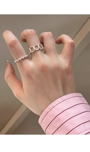 Close-up of minimalist S925 sterling silver geometric hollow and beaded rings set