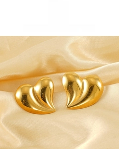 Detail view of 18K gold plated liquid heart stud earrings on golden silk fabric