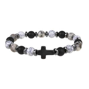 Detail of cross charm on black obsidian and white snowflake obsidian beaded bracelet