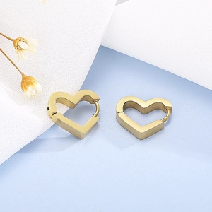 Macro detail of golden heart-shaped hoop earrings with polished metallic finish