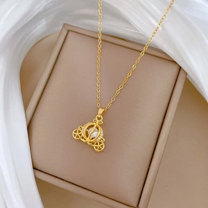 Macro view of gold pumpkin carriage pendant with sparkling crystals on a jewelry box