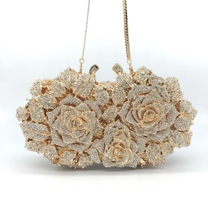 Detailed macro view of the luxurious golden rose evening bag with sparkling crystal rhinestones
